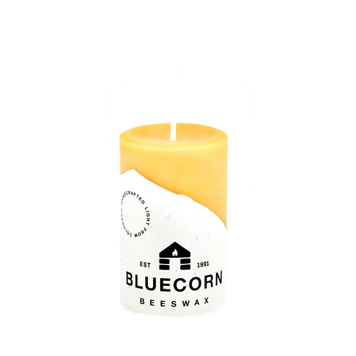 Three Bluecorn Candles pure beeswax pillar candles with natural golden color and smooth, clean-tapered design.