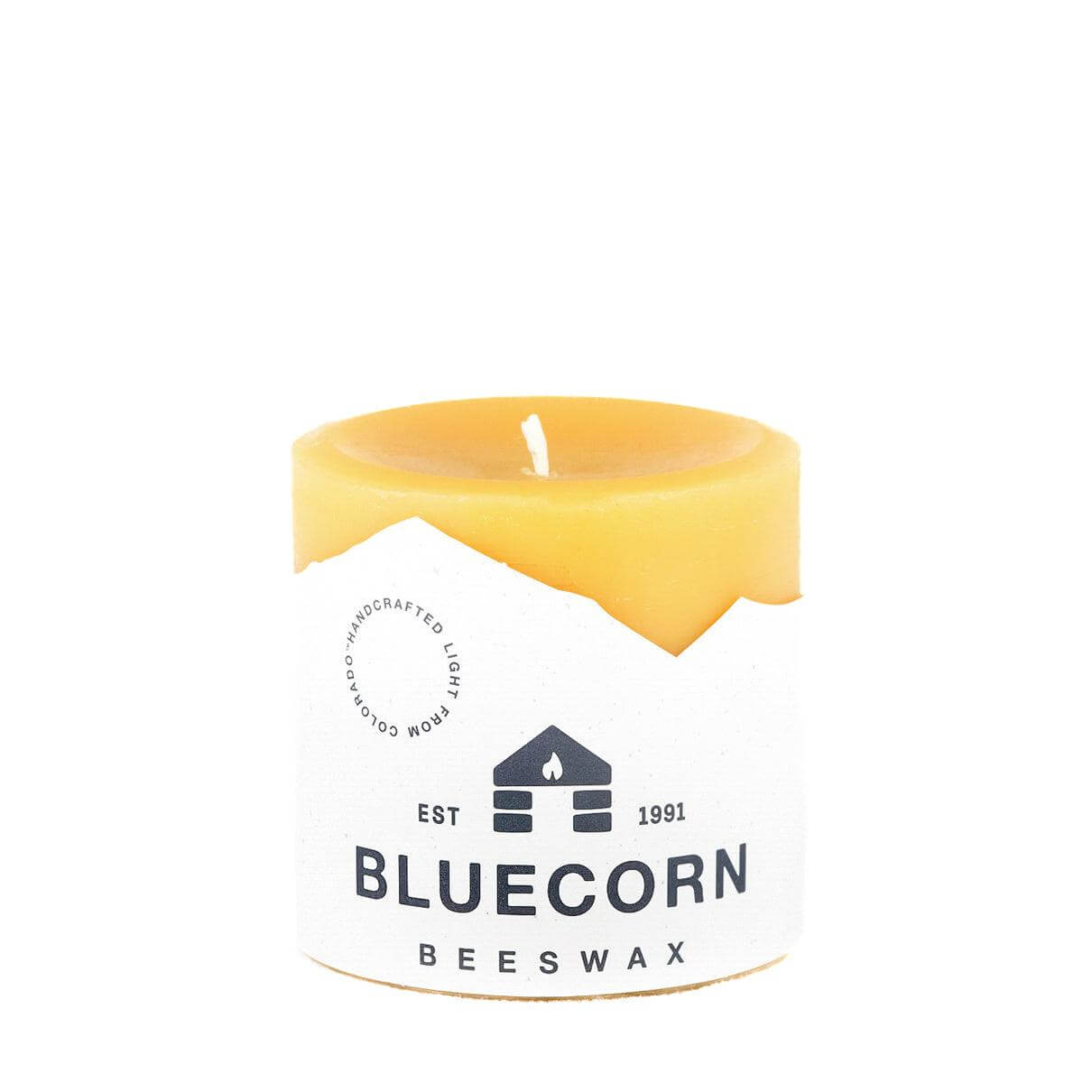 Set of blue beeswax pillar candles by Bluecorn Candles, showing their natural textured surface and warm glow.