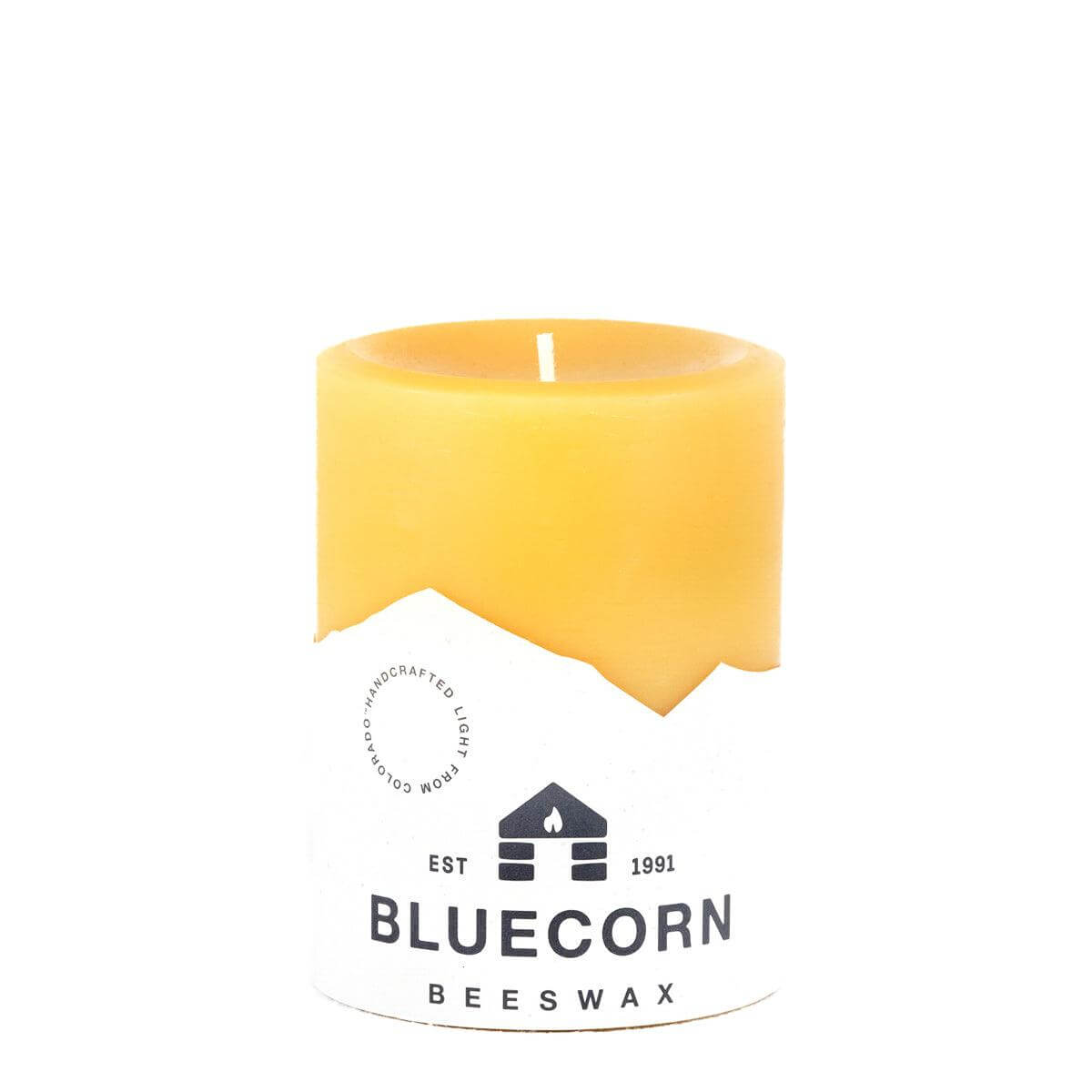 Set of three natural beeswax pillar candles by Bluecorn Candles, showcasing their warm, golden hue and smooth, cylindrical shape.