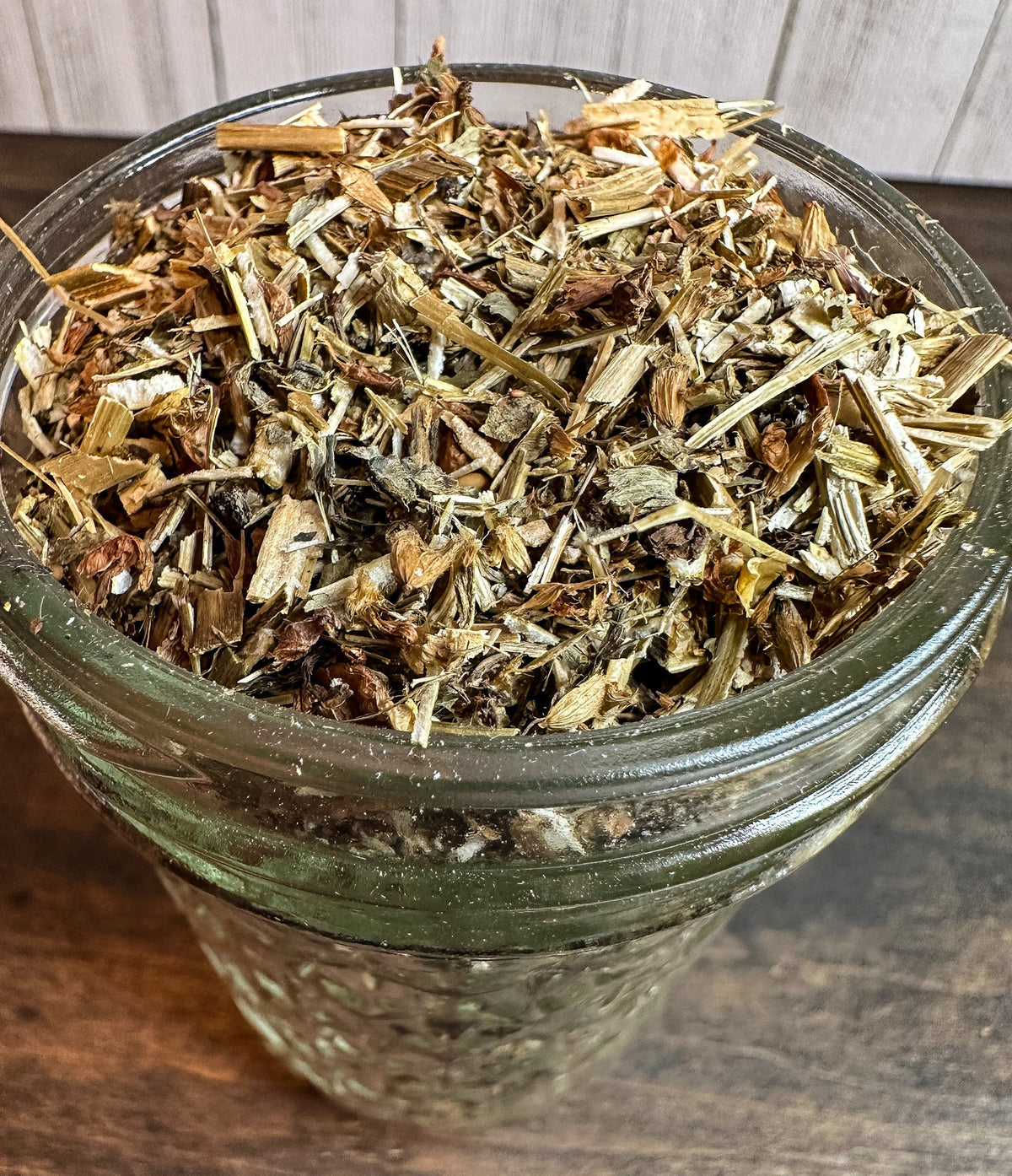 Small jar of dried red clover herbs from HerbalRoseApothecary, showcasing the herbal herb jar with a label and dried red clover inside.