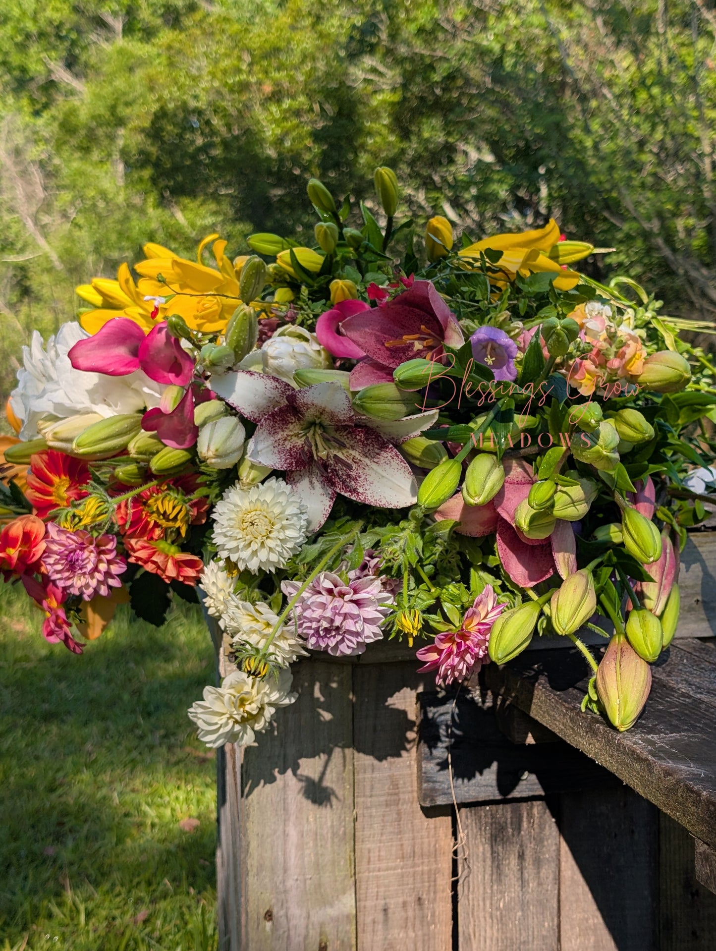 Fresh-cut flower arrangement featuring vibrant blooms in a custom deluxe Blessings Grow Meadows bouquet for events and decor.