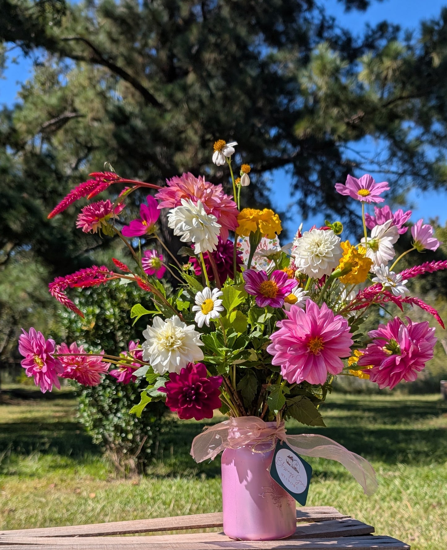 Fresh-cut flowers in a custom deluxe arrangement featuring colorful blooms from Blessings Grow Meadows Merch & More.
