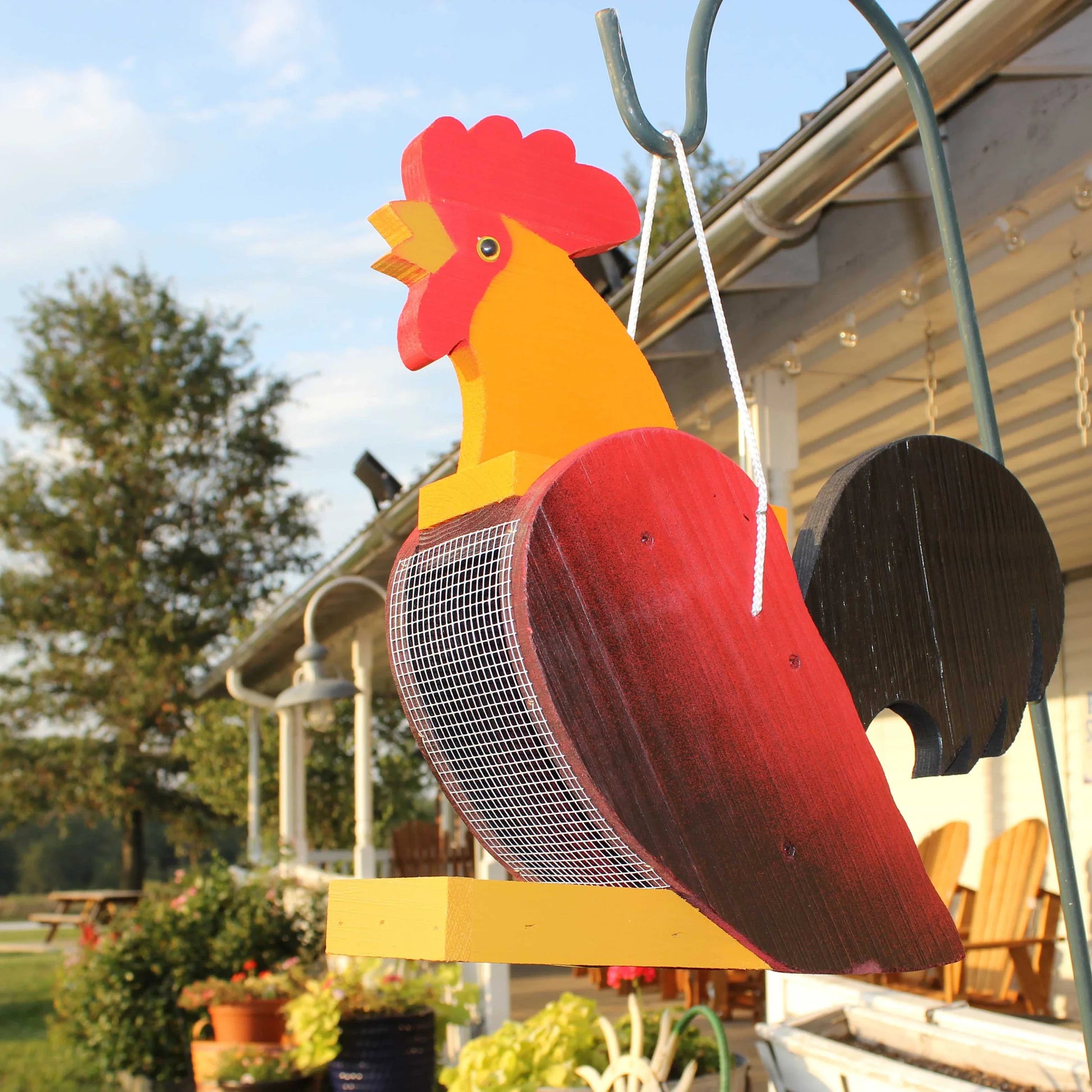 Amish-made wooden rooster-shaped bird feeder for garden decor, handcrafted with detailed bird design and natural wood finish.