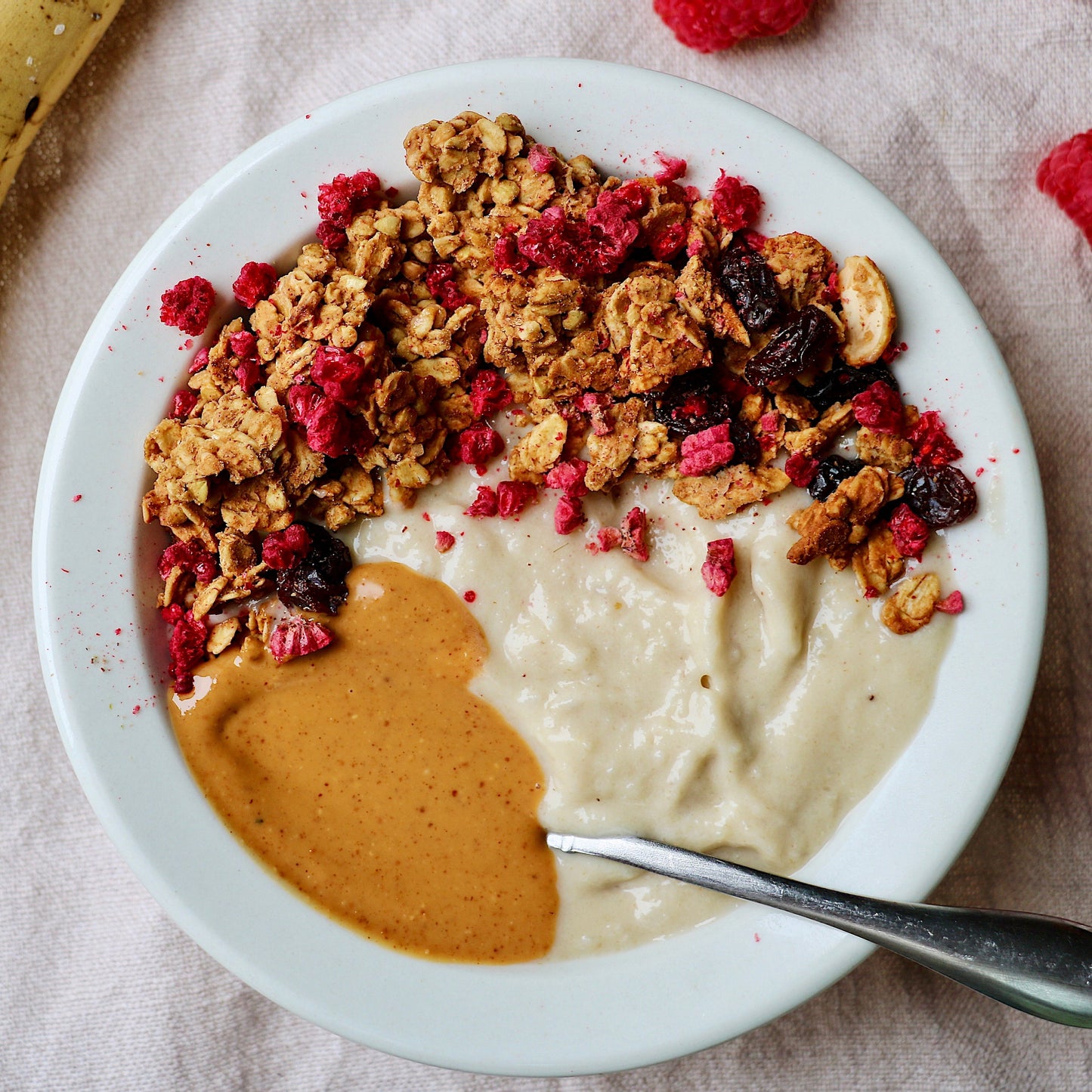 Canned Peanut Butter Crunch Granola by Rooted Living in a metal can with a label showing crunchy granola with peanut butter flavor.