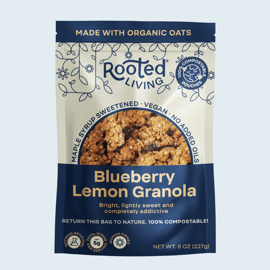 Crunchy Blueberry Lemon Granola by Rooted Living in a bowl with blueberries and lemon zest, showing the textured granola clusters.
