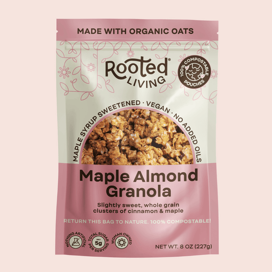 Crunchy maple almond granola from Rooted Living with visible clusters and toasted almonds in a natural setting.