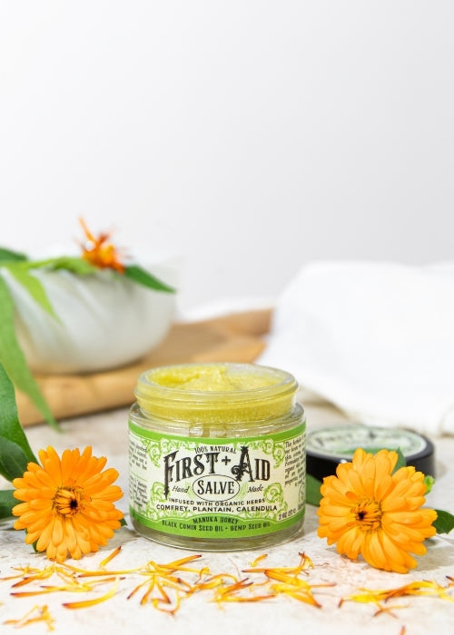 First Aid Salve by Roots and Leaves LLC, natural body care balm in a jar, suitable for soothing skin irritations and minor cuts.