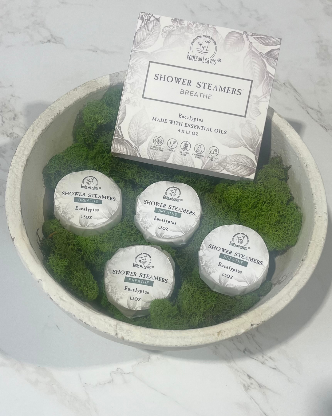 Eucalyptus shower steamer and bath bomb by Roots and Leaves LLC, featuring fresh eucalyptus scent and natural ingredients.