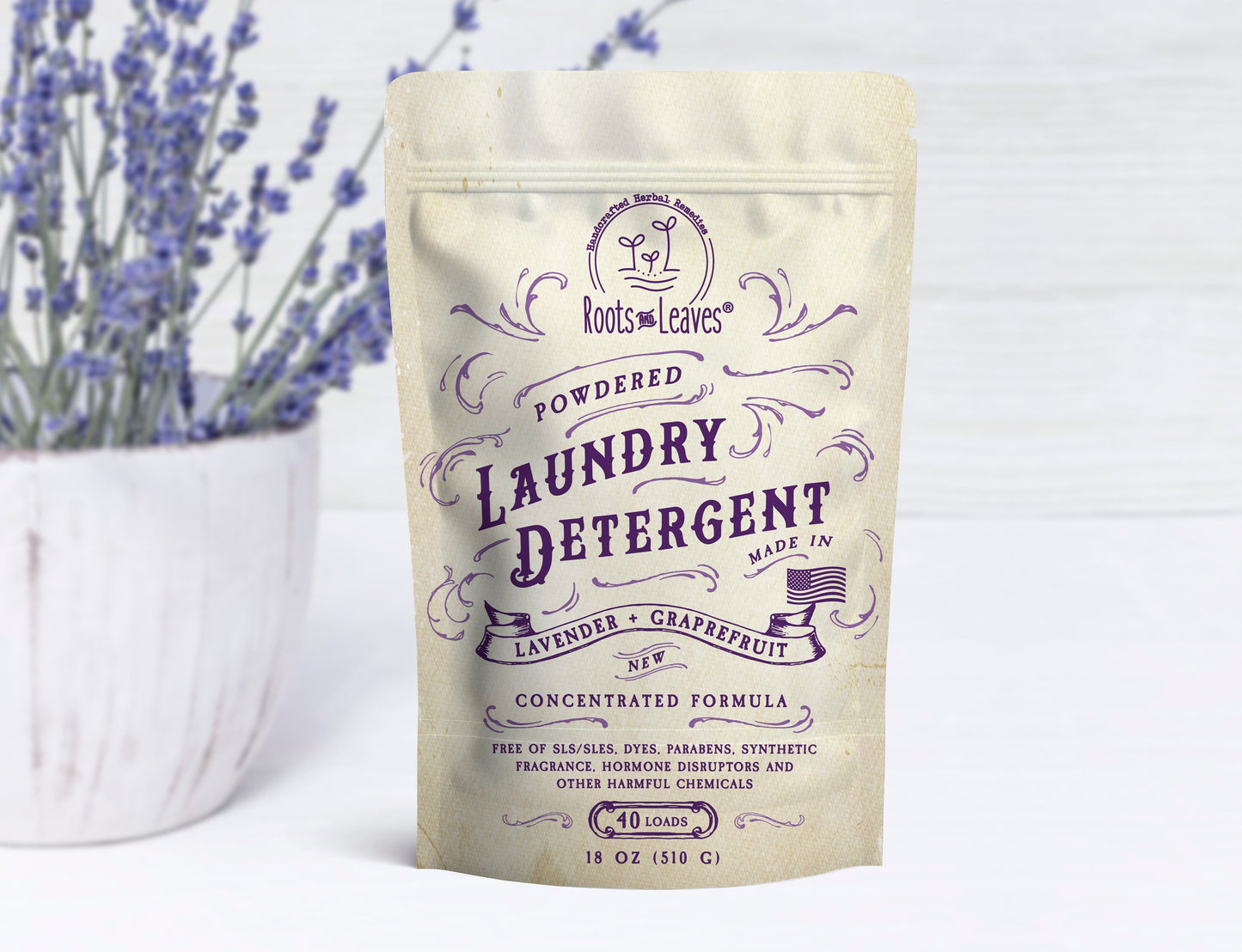 Powdered laundry detergent by Roots and Leaves LLC in a white container with a clean label, ideal for stain removal and fresh laundry.
