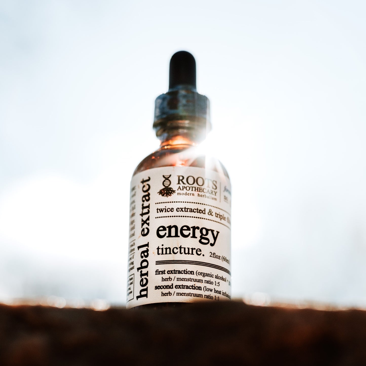 Roots Apothecary energy tincture bottle with dropper, natural herbal tincture for vitality and wellness.