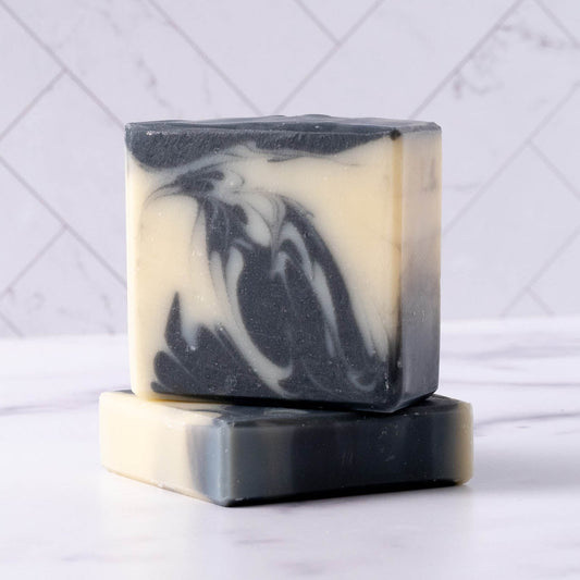 Rustic Strength detoxifying charcoal bar soap, 2.5 oz, with black soap and natural ingredients, shown in a close-up image.