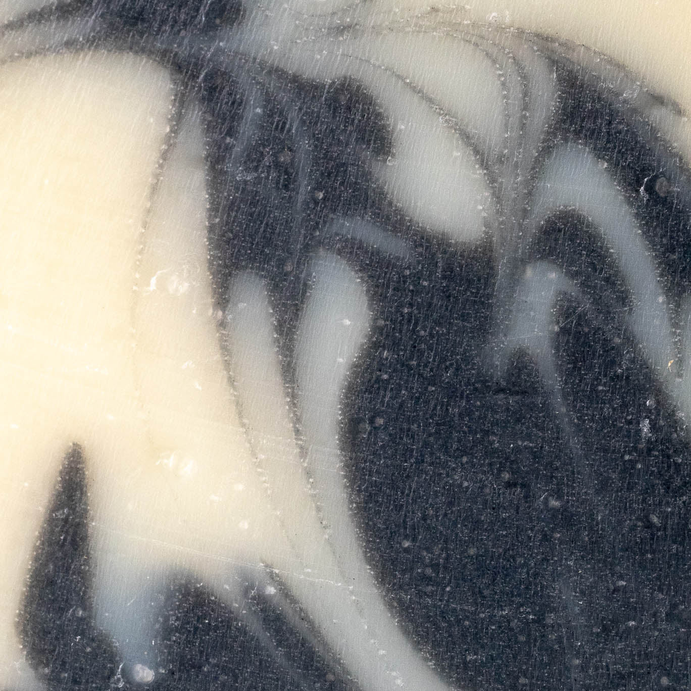 Rustic Strength detoxifying charcoal bar soap showing a dark, rectangular soap bar with textured surface for deep cleansing.