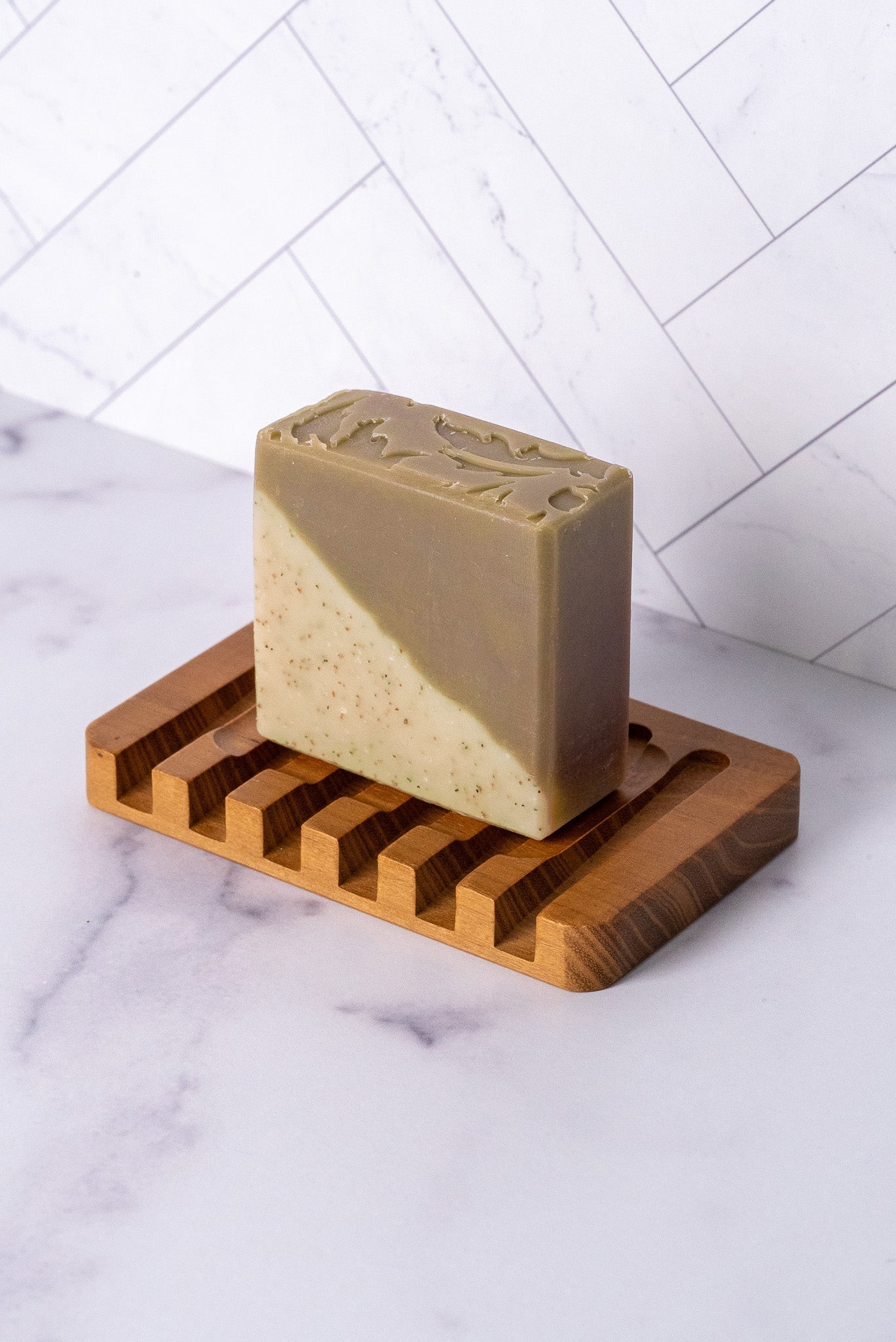 Rustic Strength sandalwood and patchouli bar soap showing a rectangular soap bar with natural earthy tones.