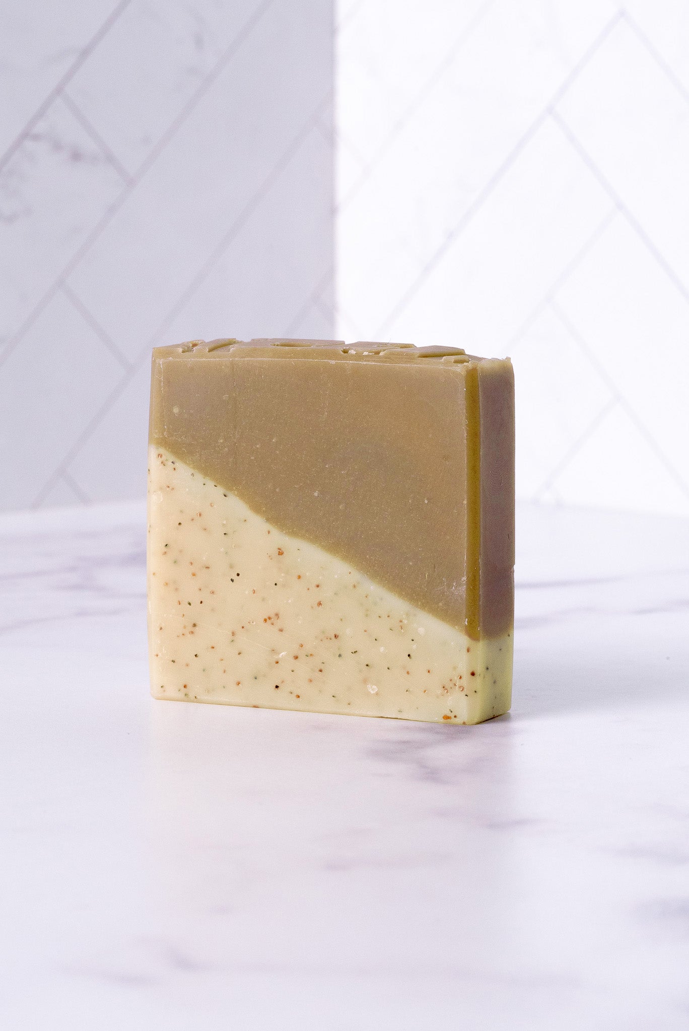 Rustic Strength sandalwood patchouli bar soap, 2.5 oz, with natural earthy scent and textured soap surface.