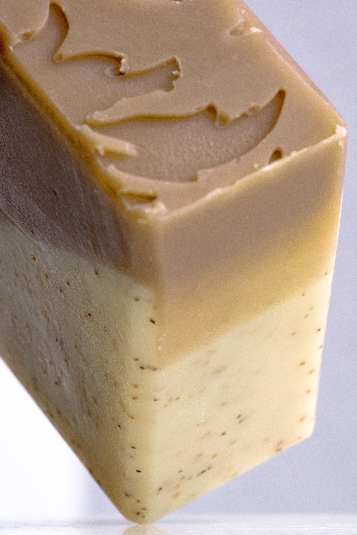 Rustic Strength sandalwood and patchouli bar soap with natural ingredients, showing a rustic soap bar on a wooden surface.