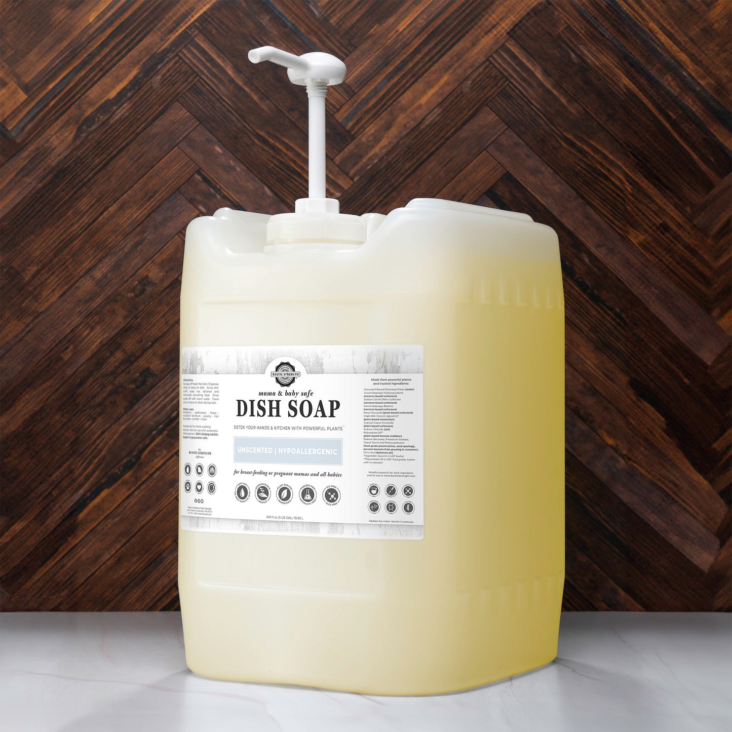 Rustic Strength dish soap in a 16 oz bottle, safe for Mama and Baby, with a clear label and green and white packaging.