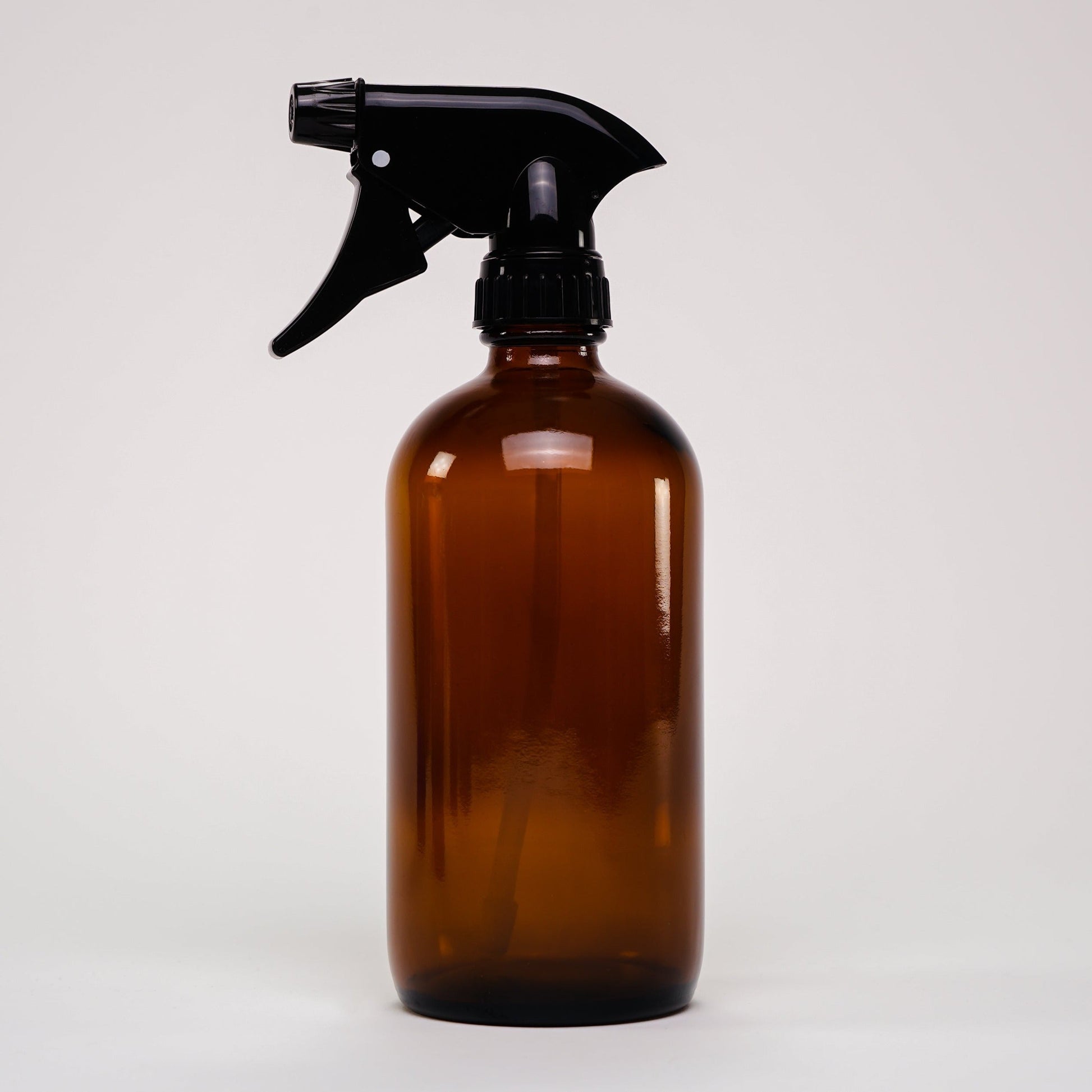 16 oz Amber Glass Keeper Bottle with spray nozzle by Rustic Strength, ideal for home and garden use.
