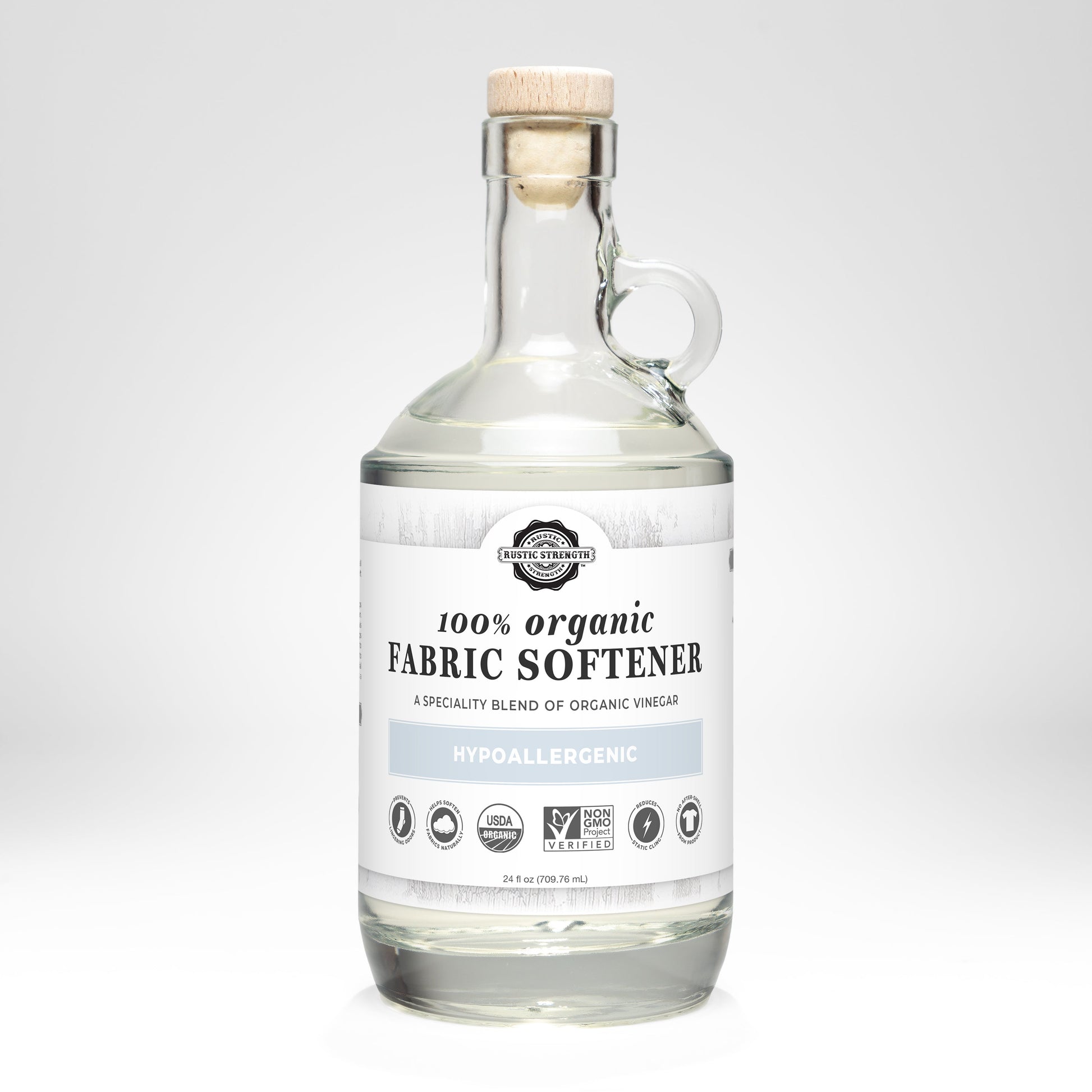 Rustic Strength Organic Fabric Softener in a 24 oz glass bottle, used for laundry to soften clothes naturally.