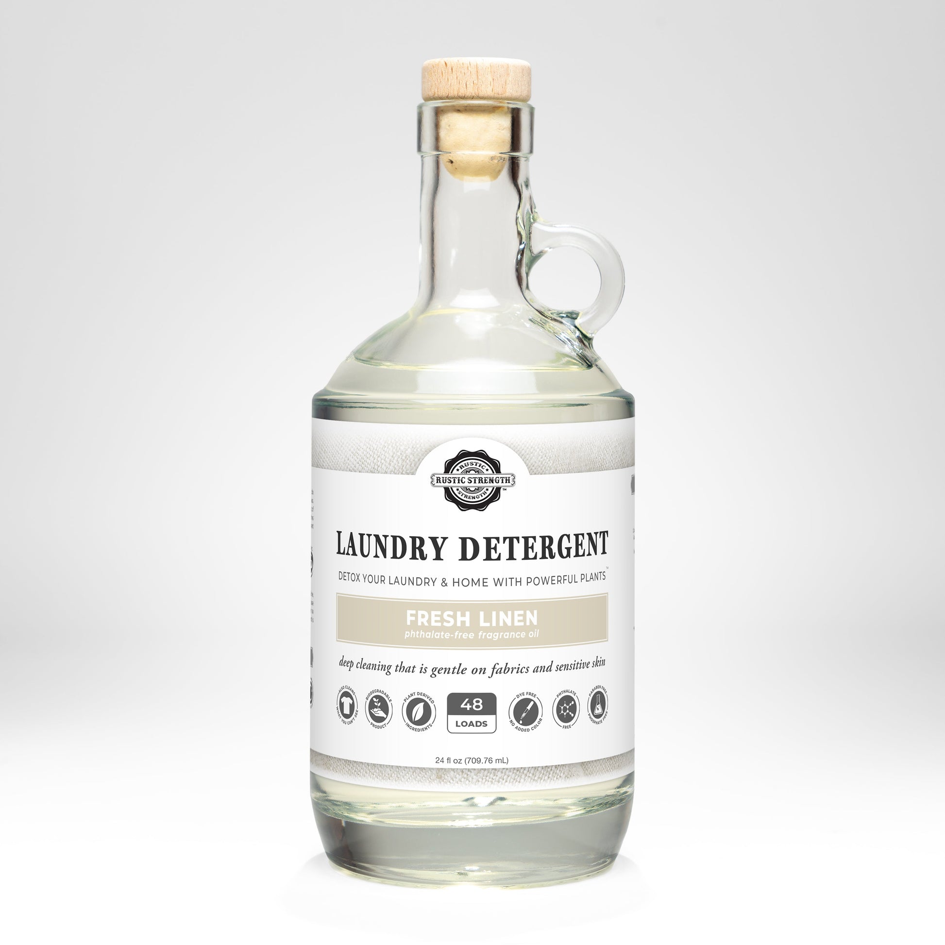 Rustic Strength Fresh Linen laundry detergent in a 24 oz glass bottle, showcasing the product with a clean and fresh scent.