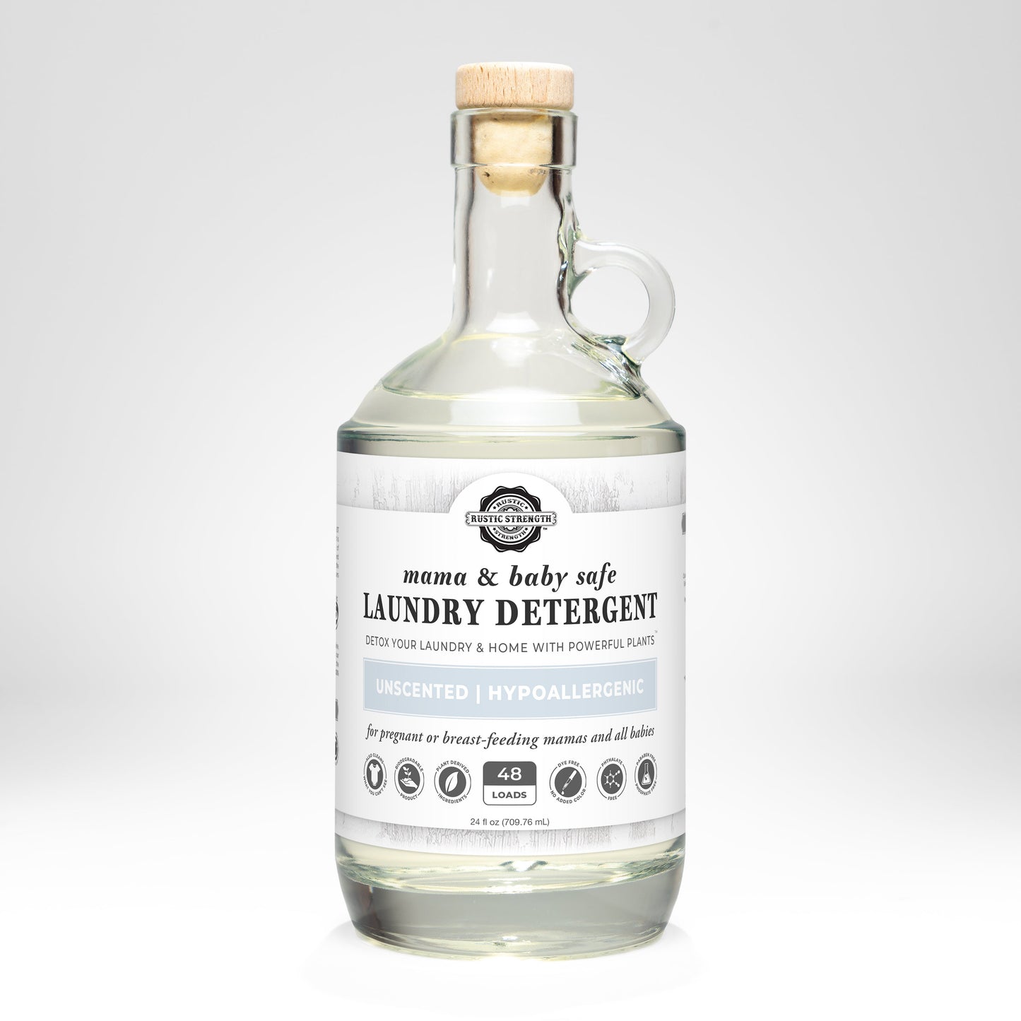 Rustic Strength laundry detergent in a 24 oz glass bottle, safe for mama and baby, gentle for delicate clothing and sensitive skin.