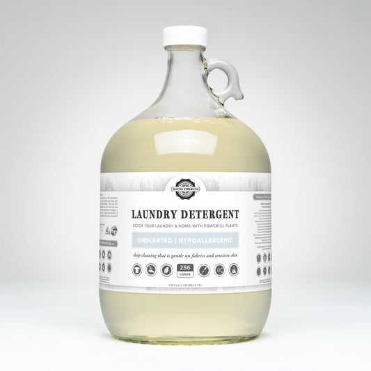 Rustic Strength unscented laundry detergent in a clear 24 oz glass bottle, suitable for gentle laundry cleaning.