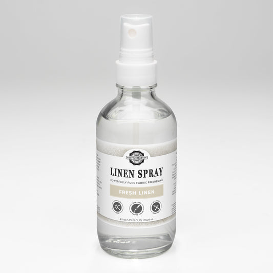 Rustic Strength Fresh Linen Spray featuring a clear glass bottle with a white spray nozzle and a minimalist label.