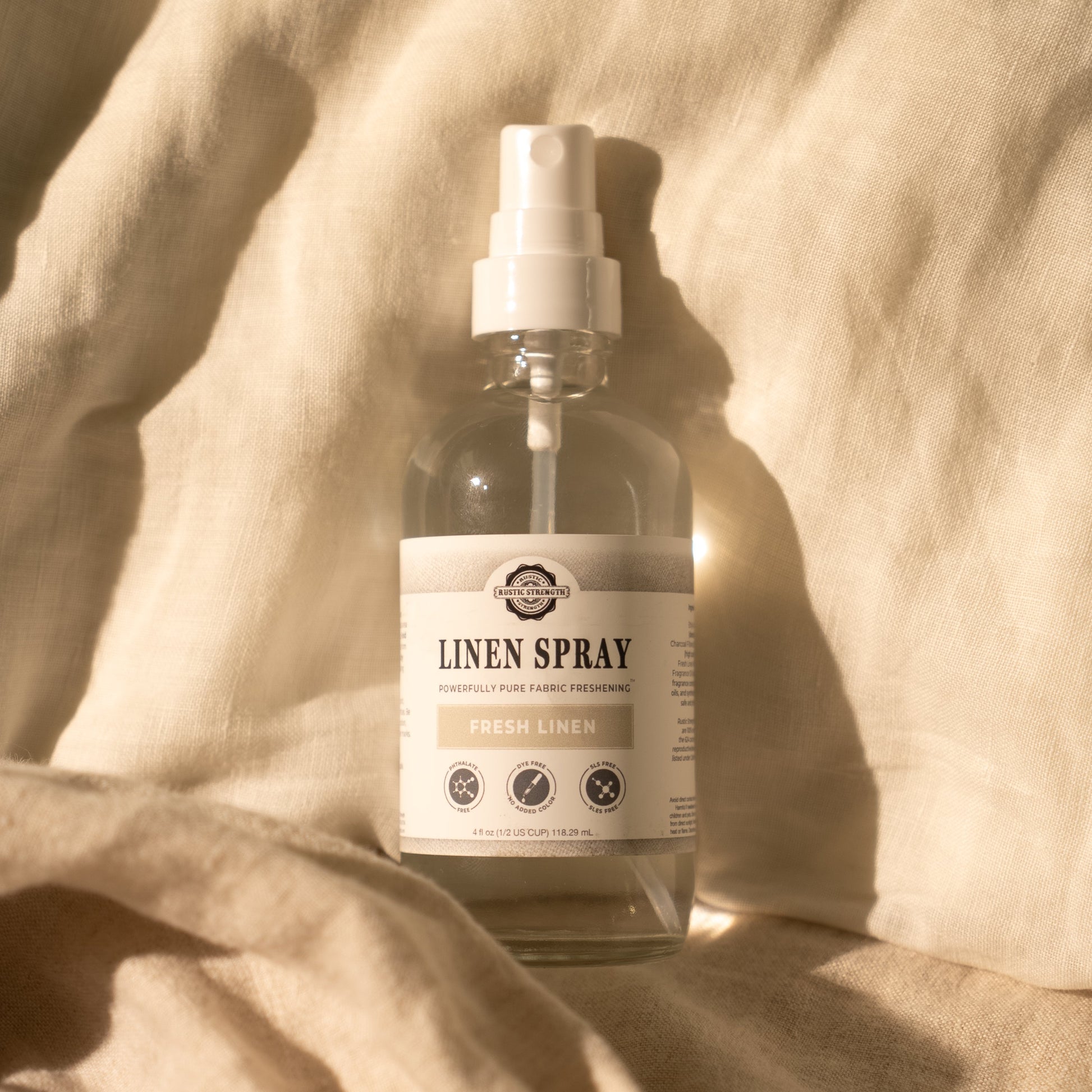 Rustic Strength Lavender Linen Spray bottle with a natural label, designed to freshen and scent linens with calming lavender aroma.