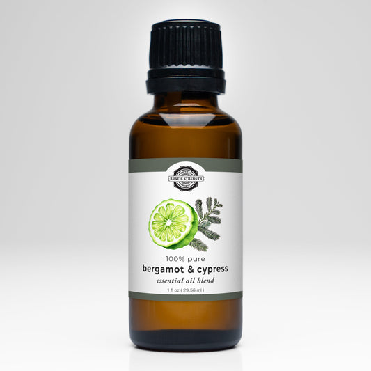 Rustic Strength Bergamot & Cypress essential oil blend scent in a glass bottle with a natural label.