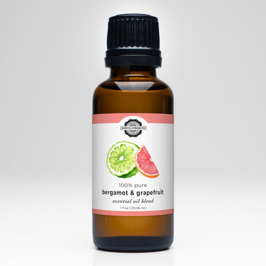 Rustic Strength Bergamot & Grapefruit Essential Oil Blend scent in a clear glass bottle with a white label and natural cork stopper.