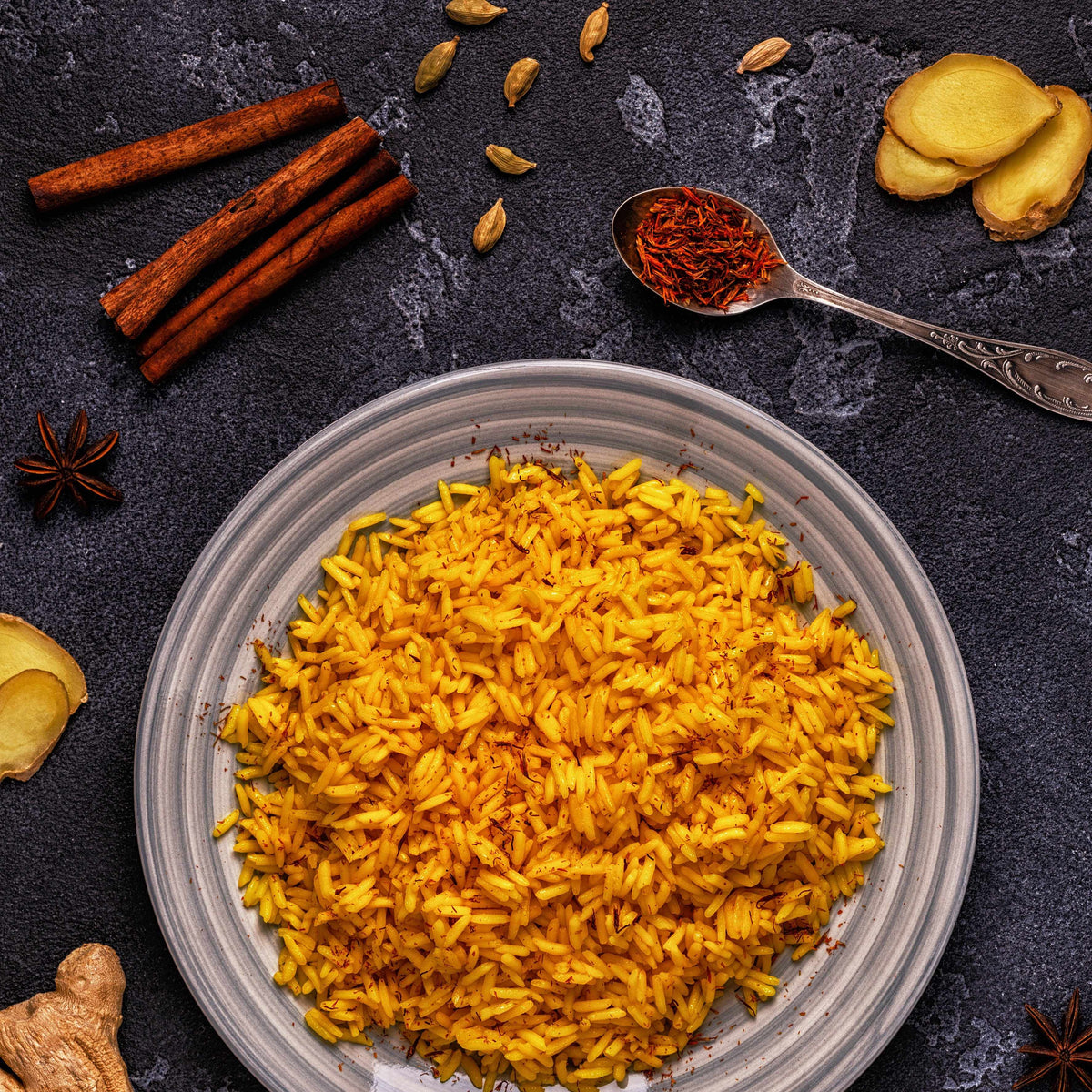 Premium Saffron Threads from Vanilla Bean Kings shown sprinkled over Persian and Basmati rice, highlighting their vibrant color and quality.
