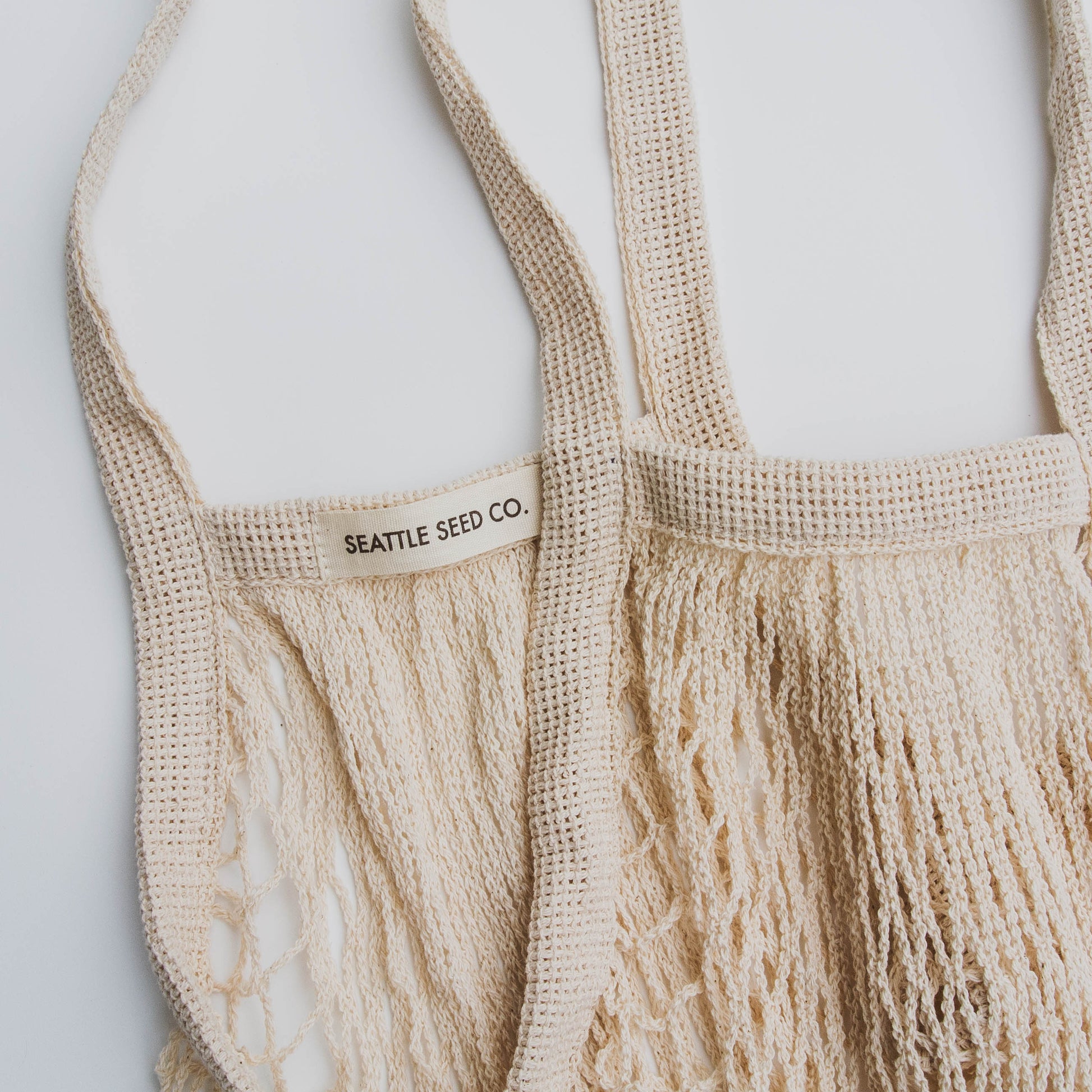 French Market Tote by Seattle Seed Company, cotton string bag with sturdy handles and spacious interior for shopping or daily use.