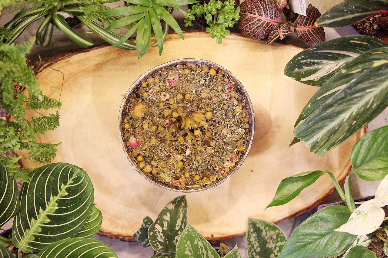 Herbal Steam Facial Blend by Seattle Seed Company with dried herbs in a bowl for skincare treatment.