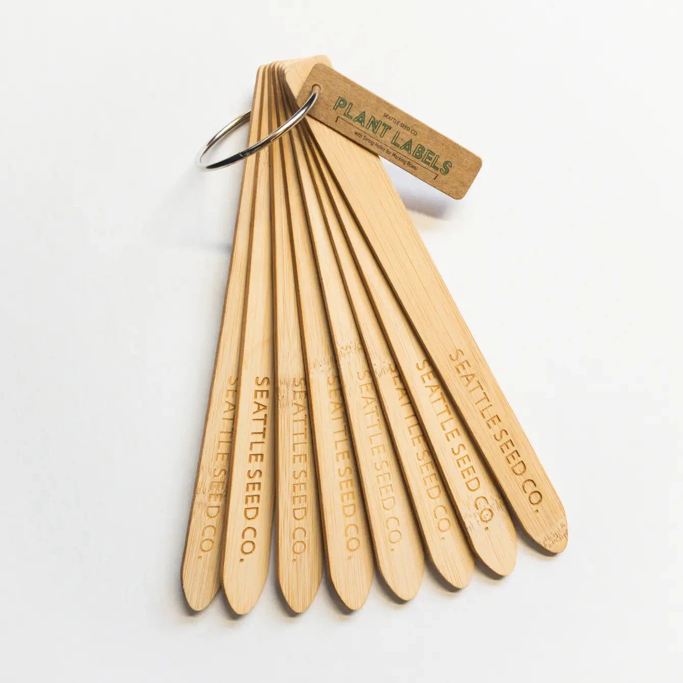 Eco-friendly wooden plant identification labels made of bamboo, designed by Seattle Seed Company for garden labeling.