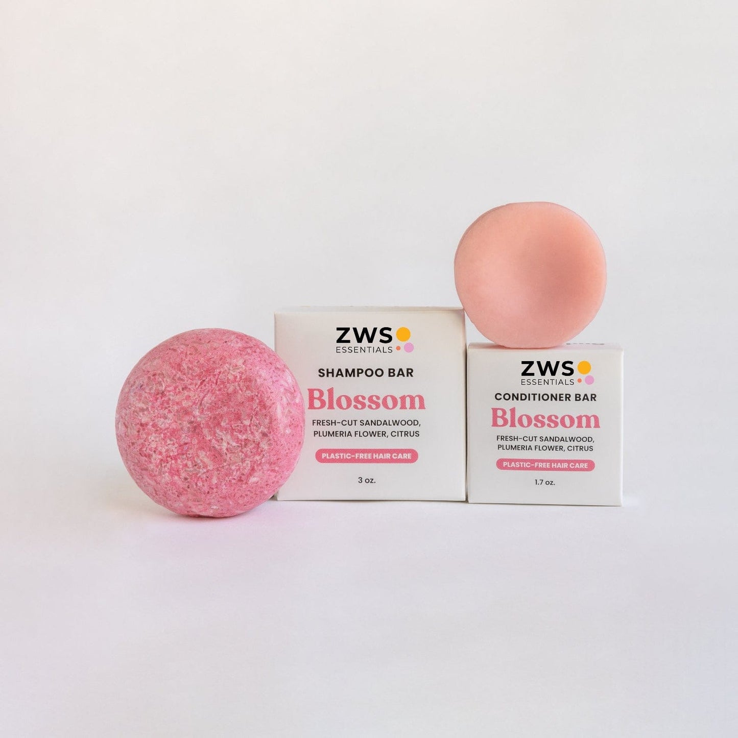 ZeroWasteStore.com shampoo and conditioner bar duo with blossom scent, eco-friendly hair care set in reusable packaging.