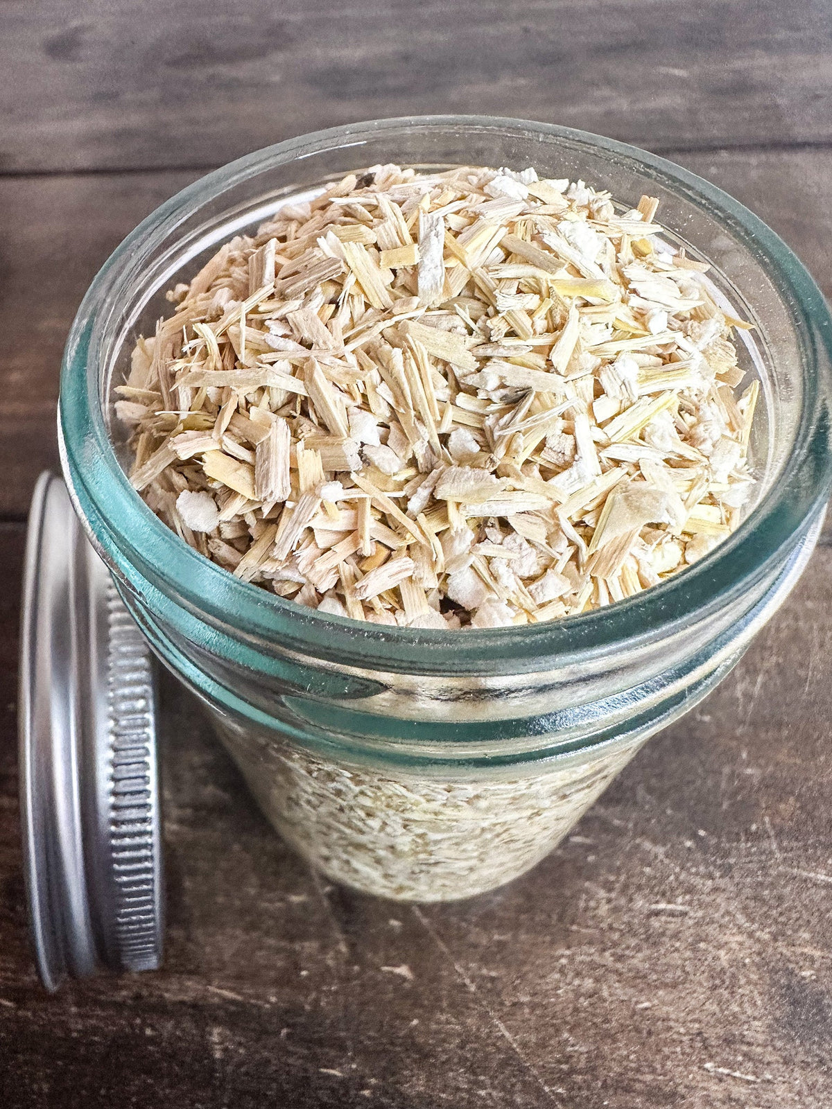 Small jar of dried Siberian ginseng herbs in a herbalroseapothecary herb jar, showing the label and herbal contents.