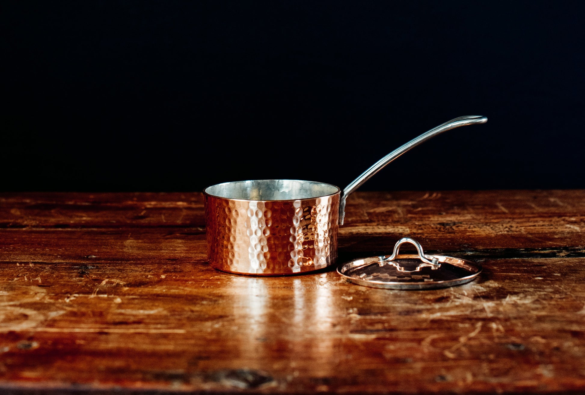 Side view of Sertodo petite French copper butter pot with lid, showcasing its small, shiny copper finish and classic design.