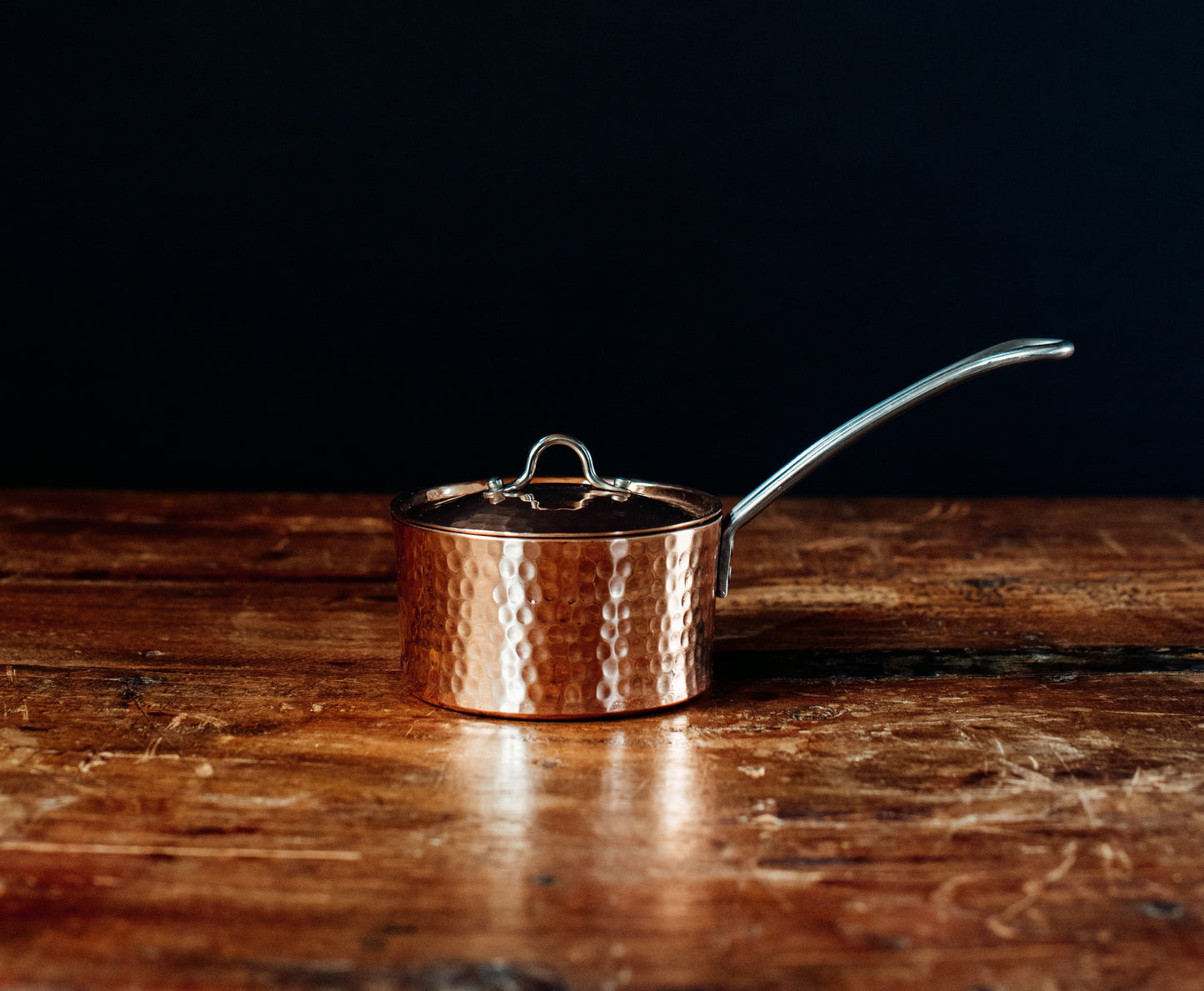 Side view of Sertodo petite French copper butter pot with lid, showcasing its smooth copper surface and classic design.