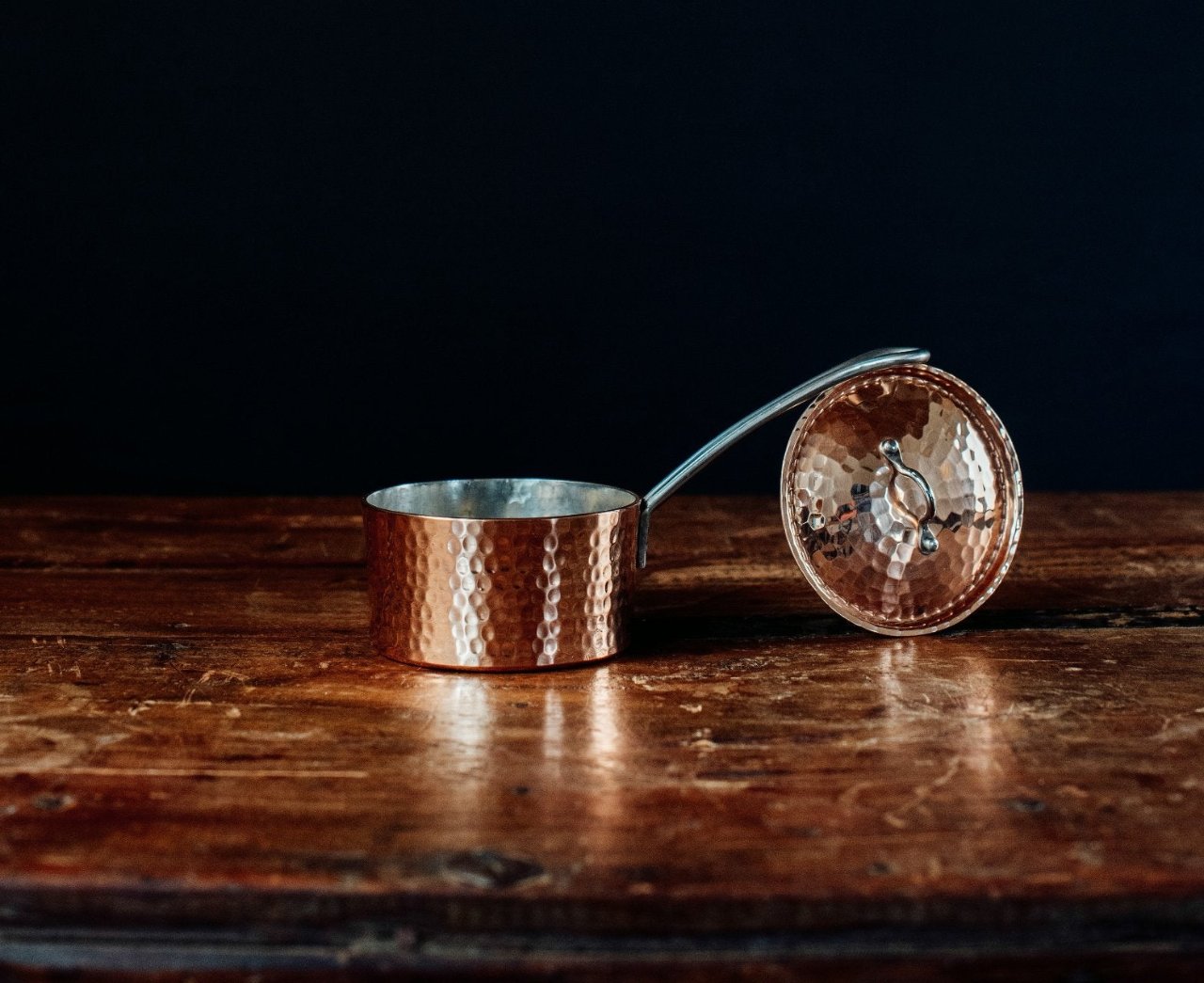 Sertodo petite French copper butter pot with lid and handle, side view, showcasing the shiny copper finish and classic design.
