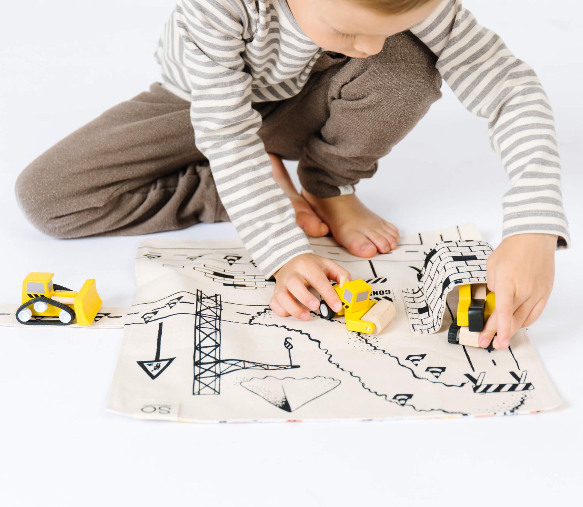 Construction Play Mat by So Handmade Shop featuring colorful construction vehicles and roads for imaginative play.