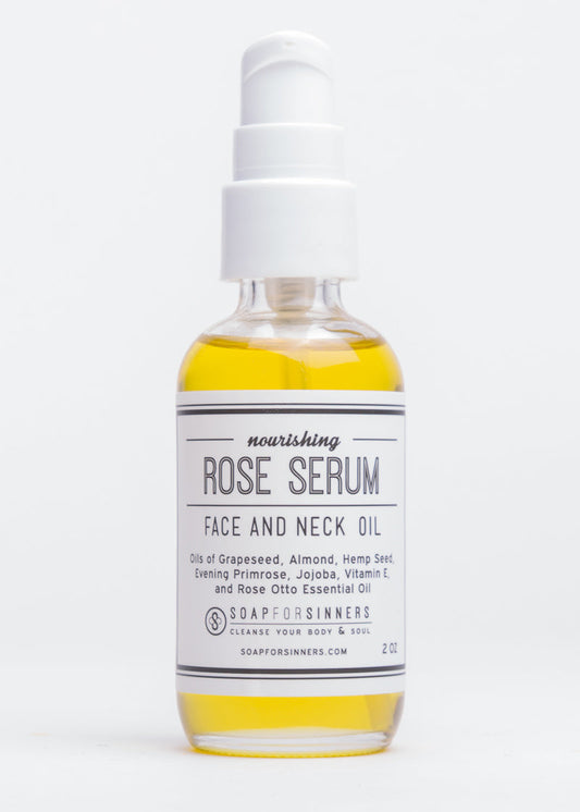 2oz bottle of Soap for Sinners Rose Serum oil, featuring a clear glass container with a dropper cap and a rose-themed label.