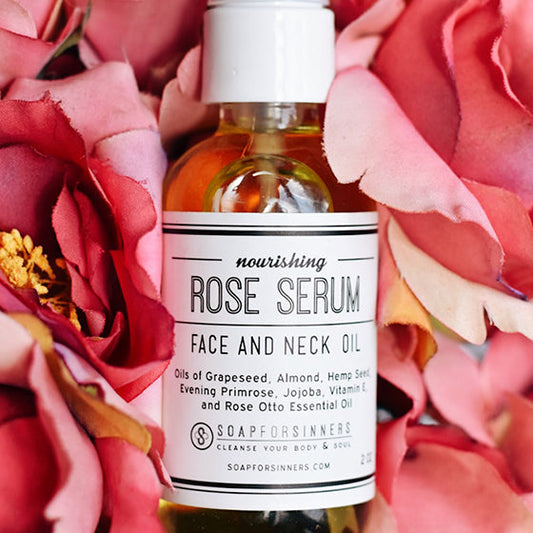 2oz Rose Serum oil by Soap for Sinners, featuring a clear bottle with a pink-tinted liquid and a minimalist label.