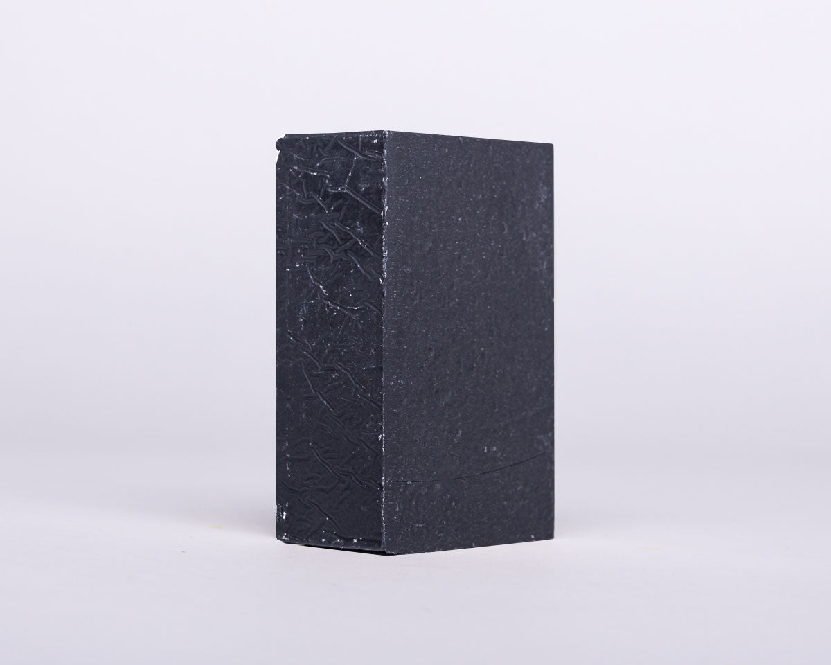 Soap for Sinners bamboo charcoal with cedarwood soap bar showing textured surface and natural ingredients.