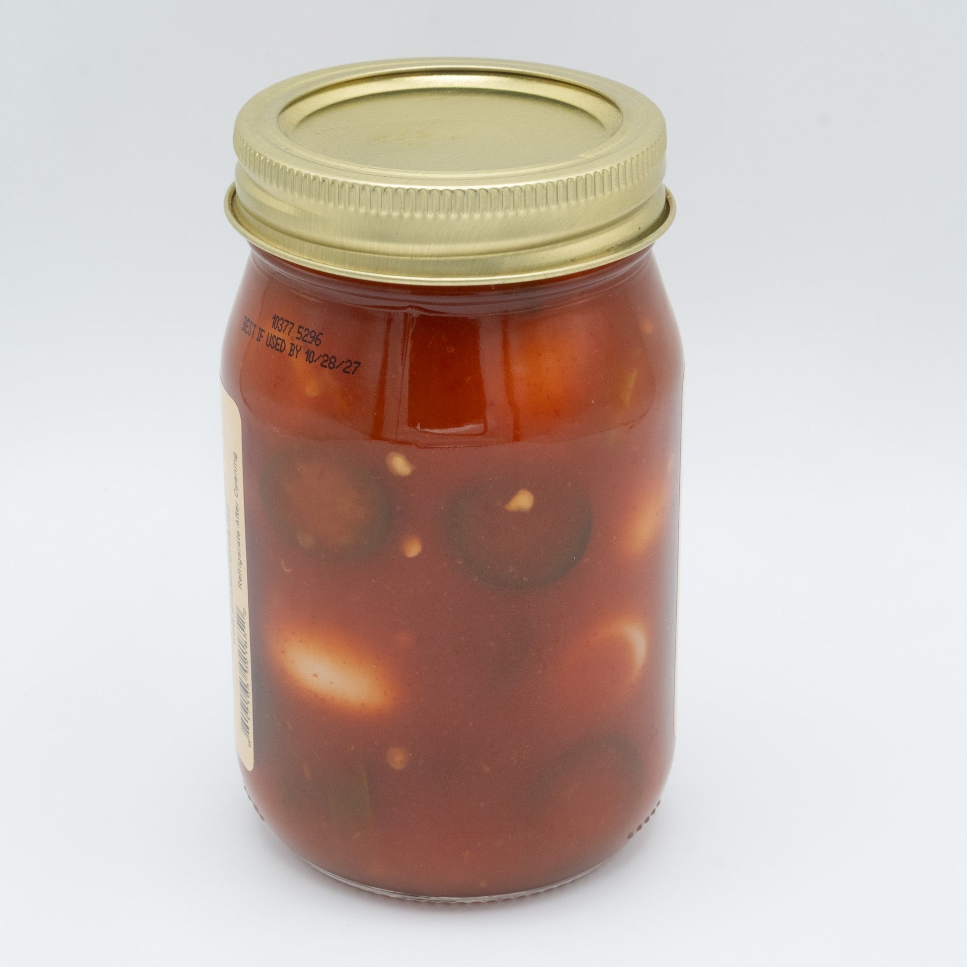Canned Pickled Sriracha Quail Eggs from Amish Country Store in a jar with vibrant red Sriracha sauce and small quail eggs inside.