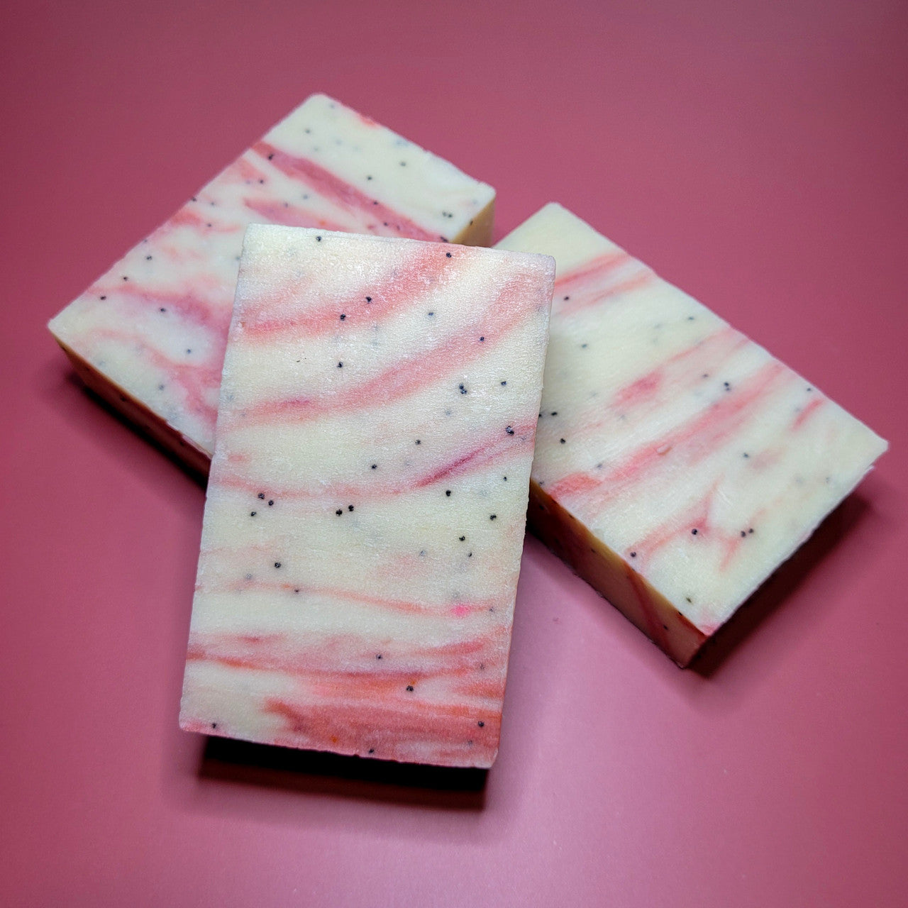 Evolve Botanica Berry Vanilla Goatmilk soap bar with natural berry and vanilla scent, showing the soap's textured surface and packaging.