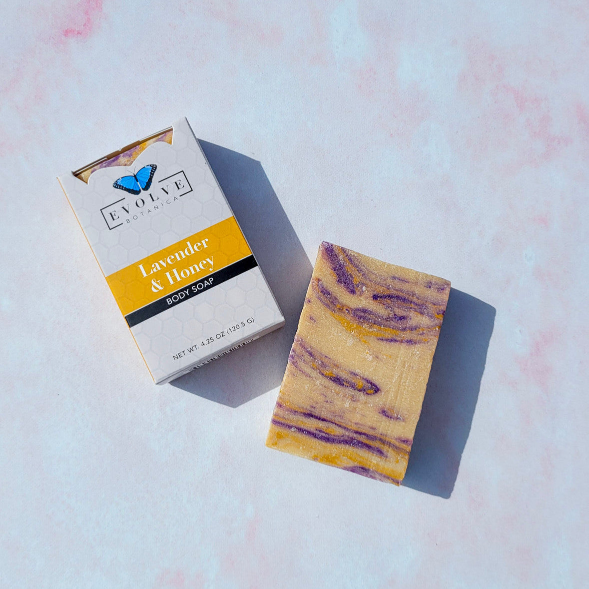 Evolve Botanica Lavender & Honey Standard Soap bar with lavender flowers and honey, showcasing a natural soap product.