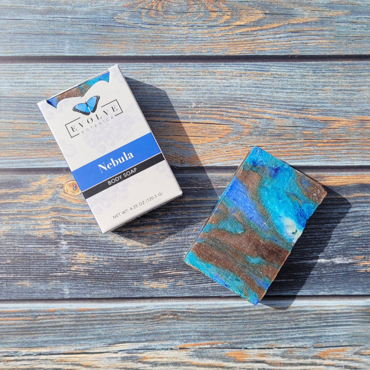 Evolve Botanica Standard Soap Nebula with blue swirls, rectangular bar with textured surface, on a neutral background.