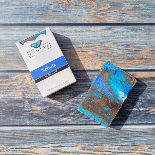 Evolve Botanica Standard Soap Nebula with blue swirls, rectangular bar with textured surface, on a neutral background.