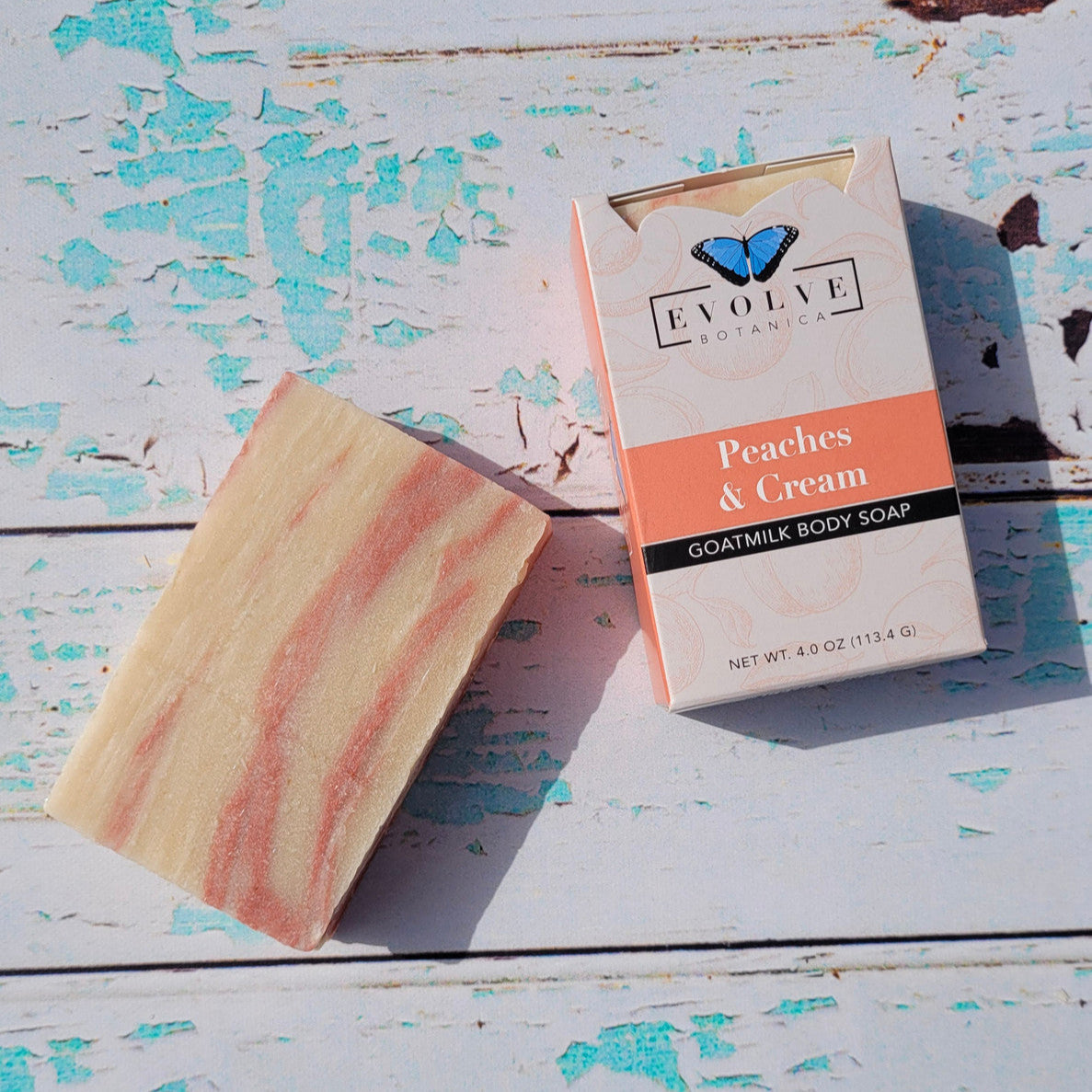 Evolve Botanica Peaches & Cream goat milk soap bar with peach and cream scent, rectangular shape, and natural packaging.