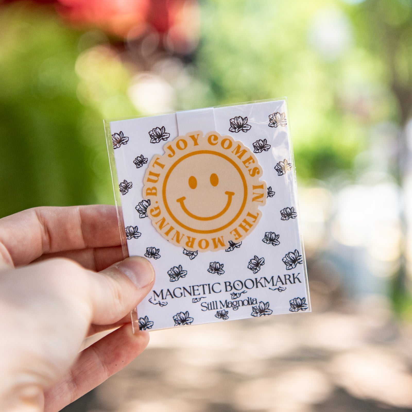 Still Magnolia magnetic bookmark titled "But Joy Comes In The Morning" featuring floral design and easy-to-use magnetic closure.