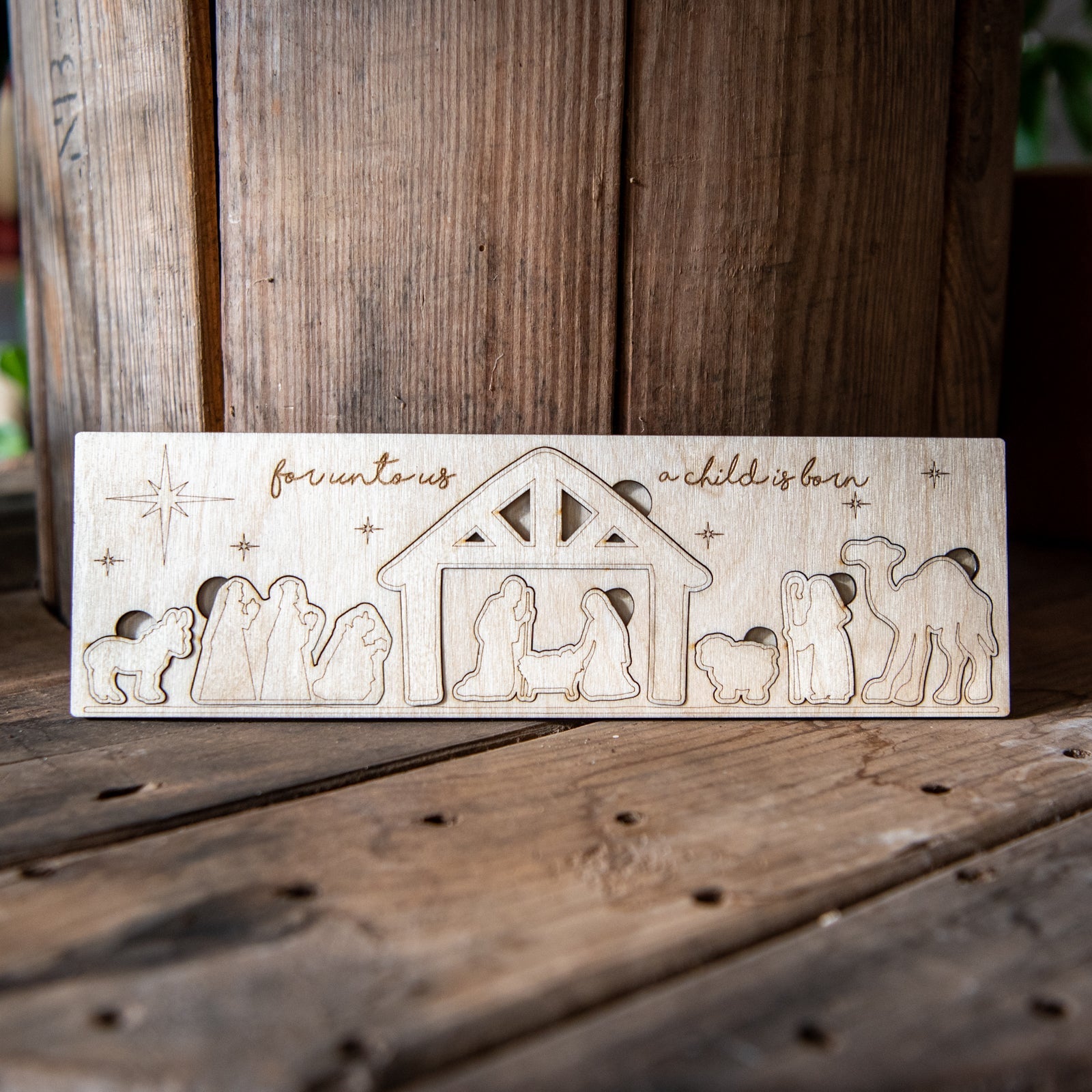 Children's Nativity Wood Puzzle by Still Magnolia, featuring colorful wooden pieces depicting the nativity scene for kids' activity.